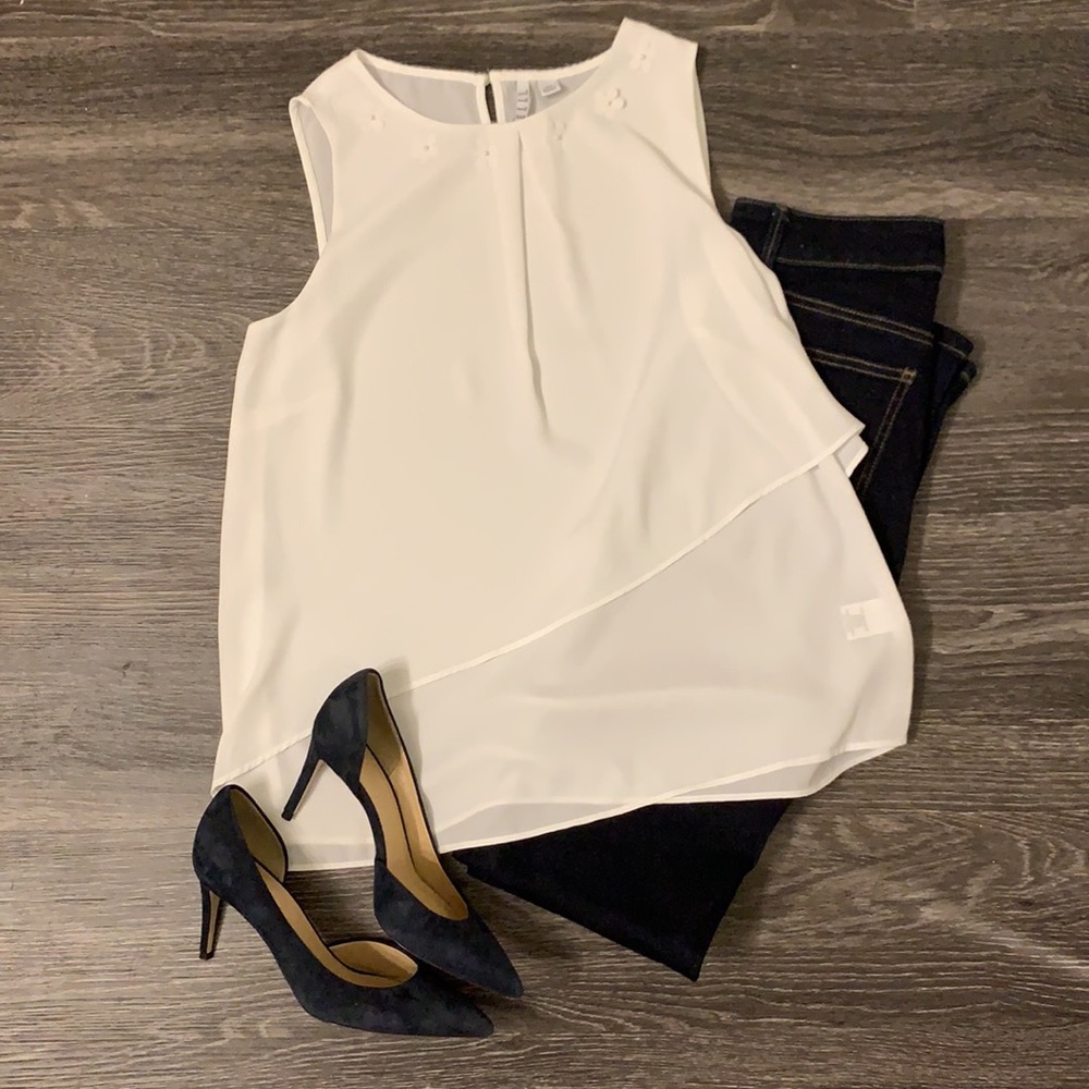 White asymmetrical blouse with flower pearl accents